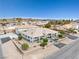 Aerial view of single story home with attached garage, mature trees and desert landscaping at 439 Cannes St, Henderson, NV 89015