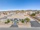 Aerial view of single story home with attached garage, mature trees and desert landscaping at 439 Cannes St, Henderson, NV 89015