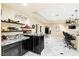 Entertaining space features wet bar with seating, display shelves, and open floor plan at 439 Cannes St, Henderson, NV 89015