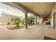 Inviting covered courtyard with stone accents, lush greenery, and shaded seating area at 439 Cannes St, Henderson, NV 89015