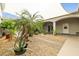 Beautifully landscaped courtyard with mature plants, gravel ground cover, and a covered patio area at 439 Cannes St, Henderson, NV 89015