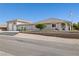 Single story home offers mature trees, desert landscaping and an attached garage at 439 Cannes St, Henderson, NV 89015