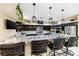 Open kitchen with black cabinets, granite counters, stainless appliances, and breakfast bar at 439 Cannes St, Henderson, NV 89015