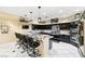 Gourmet kitchen boasts dark cabinets, granite counters, stainless appliances, and breakfast bar seating at 439 Cannes St, Henderson, NV 89015