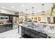 Spacious kitchen includes large island, stainless steel appliances, black cabinets, and granite counters at 439 Cannes St, Henderson, NV 89015