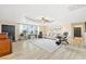 Sunlit living room boasts an elegant tray ceiling, tiled flooring and a neutral palette at 439 Cannes St, Henderson, NV 89015
