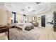 Relaxing main bedroom showcasing a tray ceiling, lots of natural light, and an attached seating area at 439 Cannes St, Henderson, NV 89015