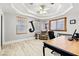 Comfortable home office with a tray ceiling, wood-look floors, natural lighting, and an inviting workspace at 439 Cannes St, Henderson, NV 89015