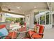 Relaxing outdoor living area under a covered patio, featuring comfortable seating and a built-in grill for entertaining at 439 Cannes St, Henderson, NV 89015
