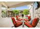 Charming outdoor patio with comfortable seating around a glass table, perfect for relaxing and entertaining guests at 439 Cannes St, Henderson, NV 89015