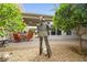 Landscaped patio featuring an iron statue, mature trees, and comfortable seating, creating a tranquil outdoor retreat at 439 Cannes St, Henderson, NV 89015