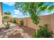 Private backyard with desert landscaping, hardscape walkway, and mature trees at 45 Via Di Mello, Henderson, NV 89011