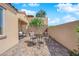 Backyard patio with stone hardscape and an outdoor dining set at 45 Via Di Mello, Henderson, NV 89011