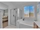 Bathroom boasts a glass-enclosed shower and soaking tub with a garden window view at 45 Via Di Mello, Henderson, NV 89011