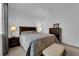 Bedroom featuring a bed, two side tables with lamps, a bench and dark wooden furniture at 45 Via Di Mello, Henderson, NV 89011