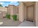 Inviting front entrance with a well-manicured garden and neutral-toned stucco at 45 Via Di Mello, Henderson, NV 89011