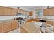 Well-lit kitchen with stainless steel appliances, light wood cabinets, and granite countertops at 45 Via Di Mello, Henderson, NV 89011