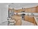Bright kitchen features stainless steel appliances and a central island with bar seating at 45 Via Di Mello, Henderson, NV 89011