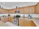 Inviting kitchen featuring light wood cabinetry, stainless steel appliances, and granite counters at 45 Via Di Mello, Henderson, NV 89011