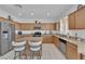 Modern kitchen with stainless steel appliances, light wood cabinets, and center island at 45 Via Di Mello, Henderson, NV 89011