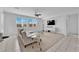 Bright living room with large windows, white sofa, and modern ceiling fan at 45 Via Di Mello, Henderson, NV 89011