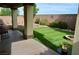 Inviting backyard patio with artificial turf, lovely hardscape and a covered porch at 4770 Lorenzo Way, Pahrump, NV 89061