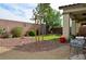 Landscaped backyard featuring desert-style gravel, artificial turf, and covered patio area at 4770 Lorenzo Way, Pahrump, NV 89061