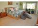 Comfortable bedroom with carpet, natural light, and a view of the outdoor space at 4770 Lorenzo Way, Pahrump, NV 89061