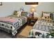 Cozy bedroom featuring two twin beds with plaid bear-themed bedding and wood-style floors at 4770 Lorenzo Way, Pahrump, NV 89061