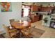 Inviting dining area with a round wooden table and a view into the kitchen space at 4770 Lorenzo Way, Pahrump, NV 89061
