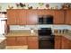 Close up of kitchen featuring sleek black appliances, wooden cabinetry, and elegant granite countertops at 4770 Lorenzo Way, Pahrump, NV 89061