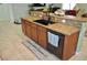 Kitchen island with black sink, granite countertops, and dark wood cabinets at 4770 Lorenzo Way, Pahrump, NV 89061