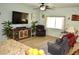Cozy living room featuring wood floors, a ceiling fan, and a comfortable seating arrangement at 4770 Lorenzo Way, Pahrump, NV 89061