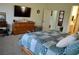 Spacious main bedroom with a queen-sized bed and dresser with access to ensuite at 4770 Lorenzo Way, Pahrump, NV 89061