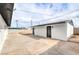 Backyard featuring a spacious concrete area, white walls, and sunny skies at 4957 E Harmon Ave, Las Vegas, NV 89121