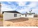 Backyard featuring a spacious dirt area, white walls, and sunny skies at 4957 E Harmon Ave, Las Vegas, NV 89121