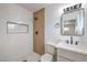 Beautiful bathroom featuring a marble-tiled walk-in shower, vanity, and modern fixtures at 4957 E Harmon Ave, Las Vegas, NV 89121