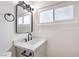 Bathroom featuring a stylish mirror, modern fixtures, and white countertops at 4957 E Harmon Ave, Las Vegas, NV 89121