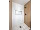 Bathroom featuring new tile shower with built-in shelf and matte black hardware at 4957 E Harmon Ave, Las Vegas, NV 89121