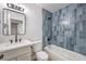 Bathroom featuring stylish blue tile, modern vanity, and bathtub at 4957 E Harmon Ave, Las Vegas, NV 89121