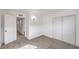 Bedroom with a view to the hallway, neutral carpet, and fresh white paint at 4957 E Harmon Ave, Las Vegas, NV 89121