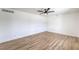 Bright bedroom showcasing updated flooring, modern ceiling fan and ample natural light at 4957 E Harmon Ave, Las Vegas, NV 89121