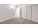 Bedroom with a view to the bathroom, neutral carpet, and fresh white paint at 4957 E Harmon Ave, Las Vegas, NV 89121