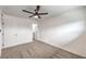 Bright bedroom with a ceiling fan, carpeted floors, and fresh white paint at 4957 E Harmon Ave, Las Vegas, NV 89121
