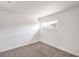 Bedroom featuring neutral carpet, white walls, and minimalist design at 4957 E Harmon Ave, Las Vegas, NV 89121