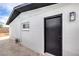 Exterior shot showing a side door and window, highlighting the home's design and access points at 4957 E Harmon Ave, Las Vegas, NV 89121