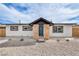 Charming single-story home with a modern front entrance and low-maintenance front yard at 4957 E Harmon Ave, Las Vegas, NV 89121