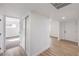 Hallway with wood-look floors and access to a bedroom with closet and carpet at 4957 E Harmon Ave, Las Vegas, NV 89121