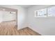 Hallway featuring updated flooring, neutral walls, and open access to the living area at 4957 E Harmon Ave, Las Vegas, NV 89121