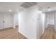 Hallway with wood-look floors leading to bedrooms at 4957 E Harmon Ave, Las Vegas, NV 89121